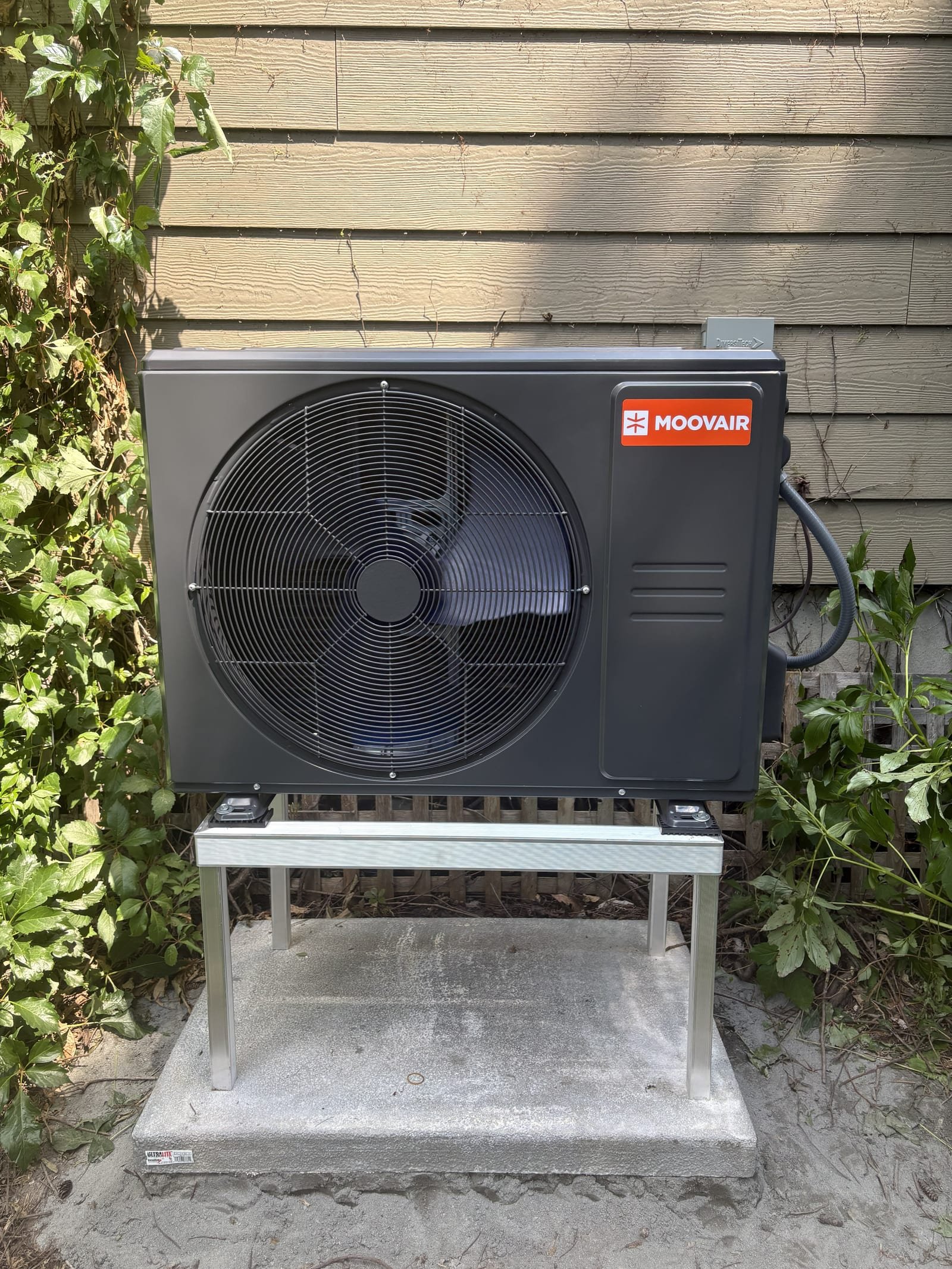 Moovair outdoor heat-pump unit on a raised metal stand